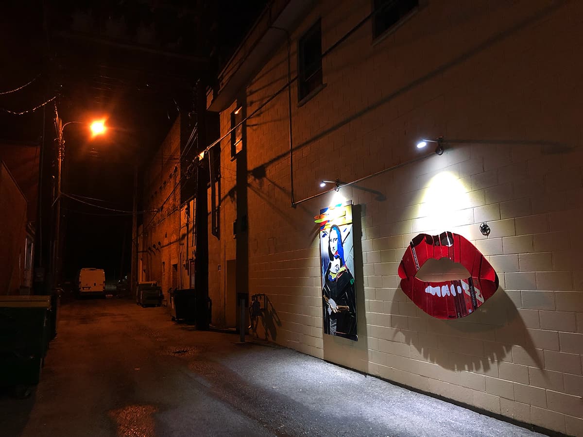 art lit up in alleyways