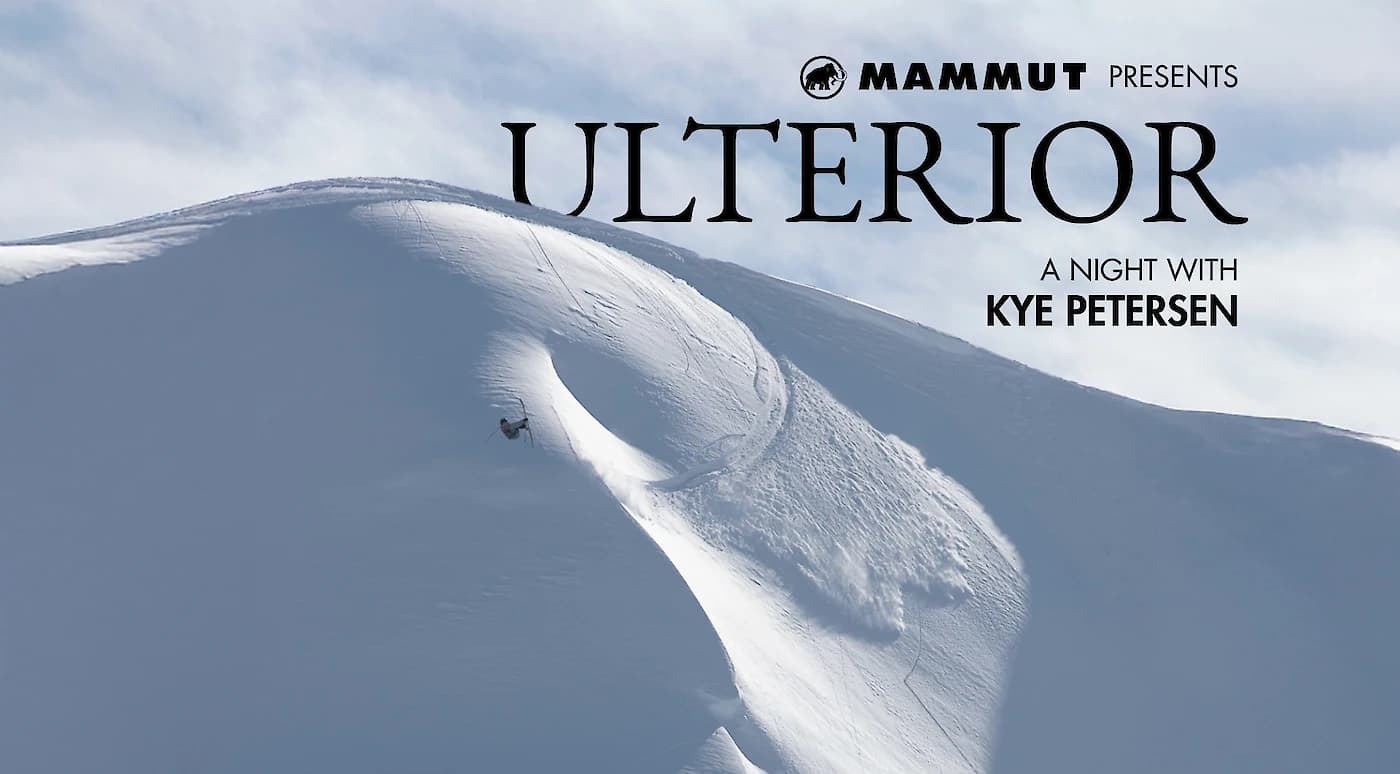 Snowboarder descending a steep, pristine snow-covered mountain slope under a clear sky, with text overlay for "Ulterior" and "Kye Petersen."
