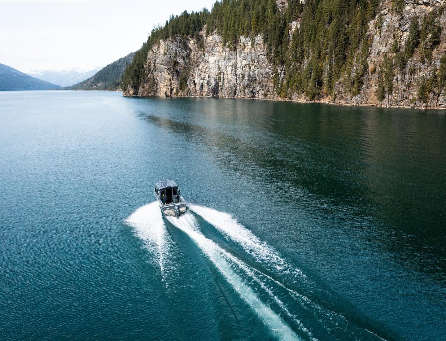 boating along lake near cliff face
