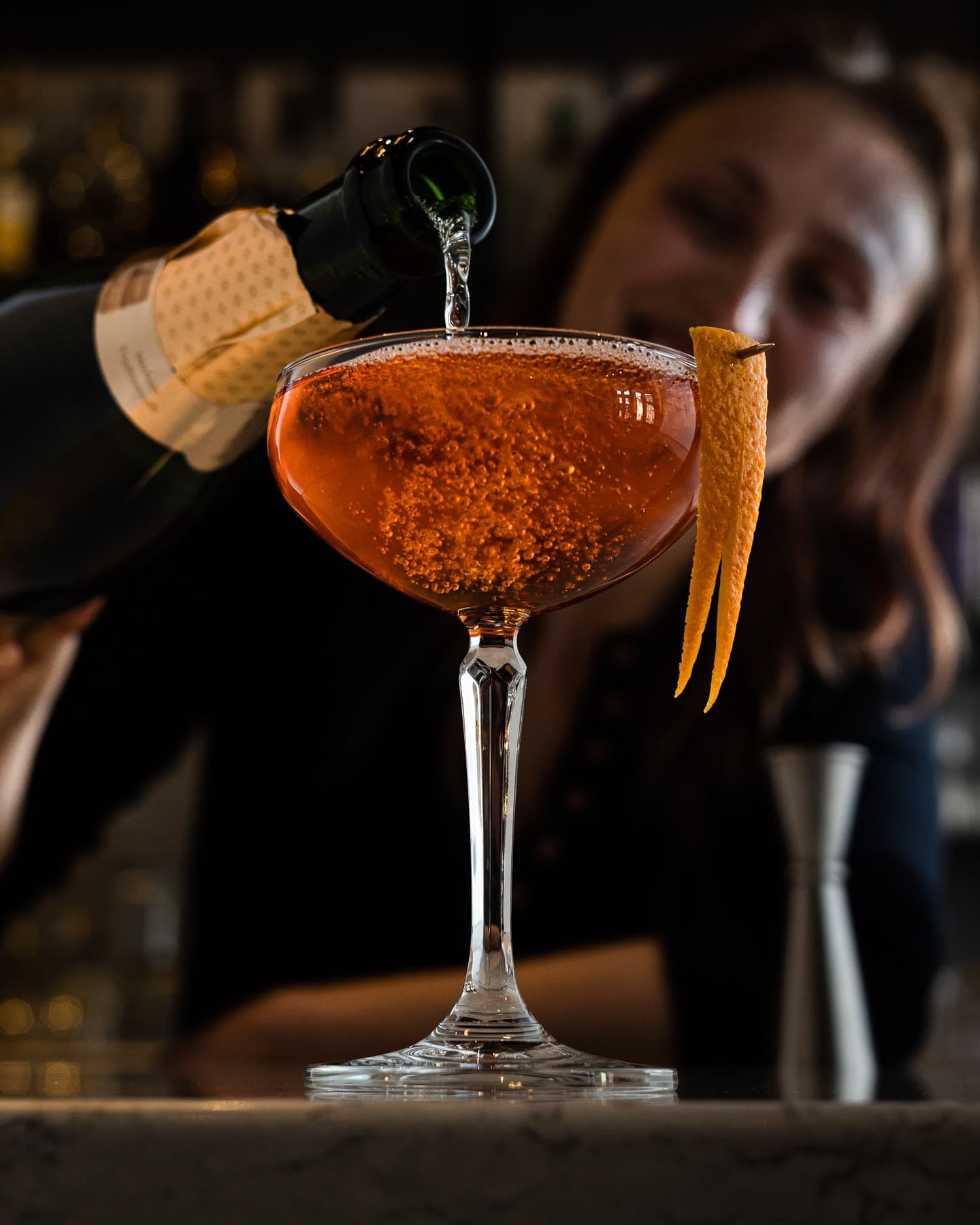 pouring sparking wine into cocktail