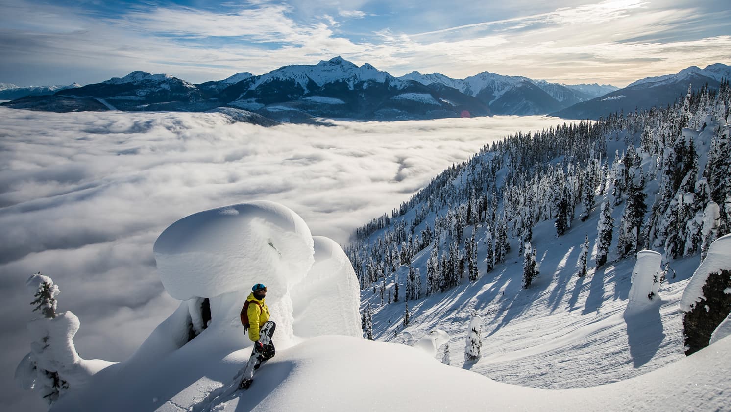 snowboarder on a powder pillow looking out