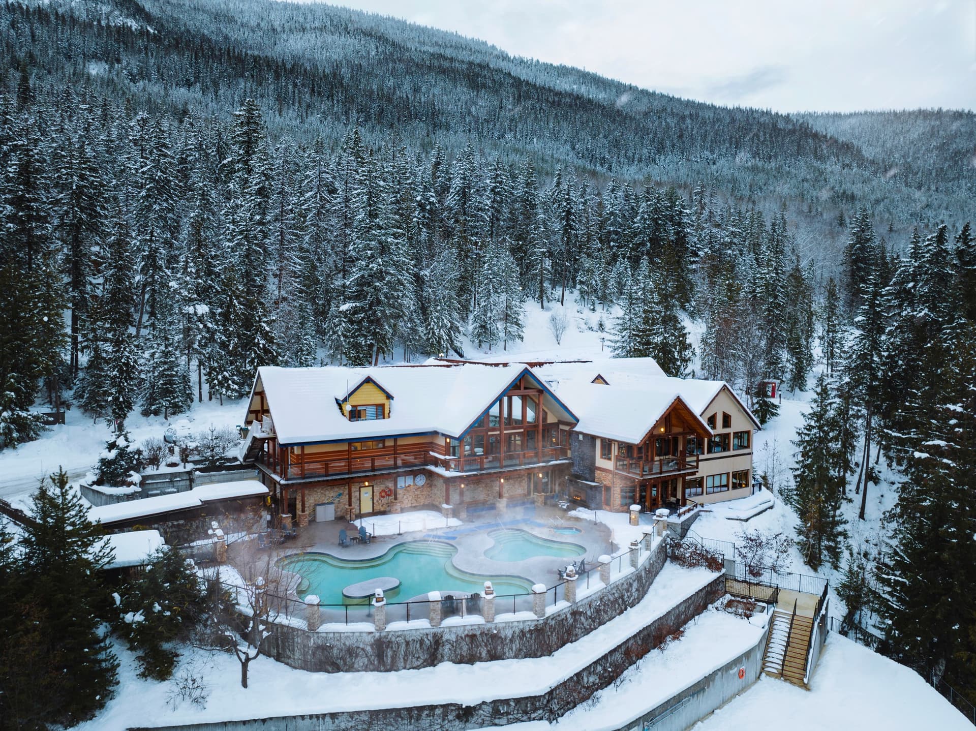 lodge and large pools steaming in the snowy covered landscape