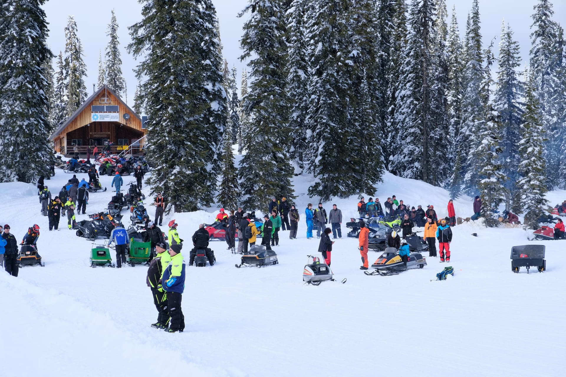 snowmobilers gathering for event at cabin