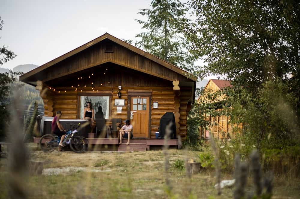 log cabin with people sitting outside