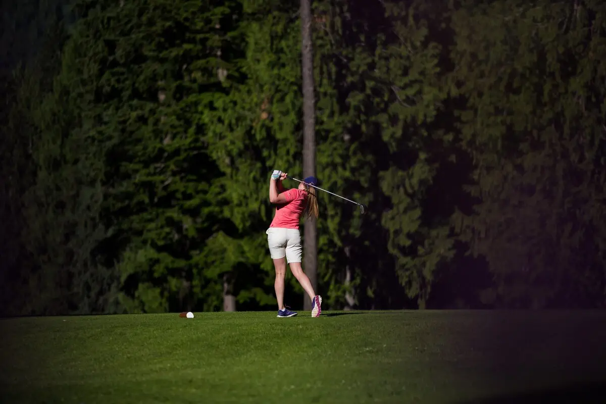 Woman swinging Revelstoke Golf Club