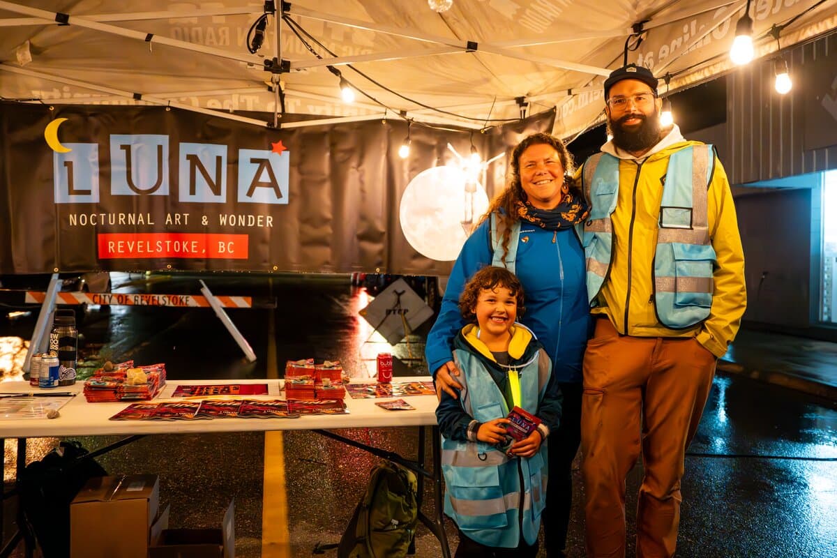 family of volunteers at night art festival