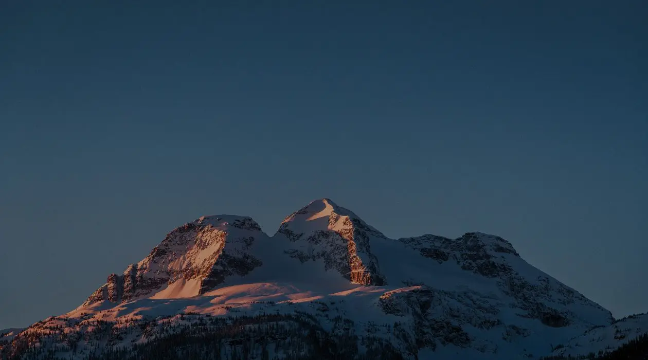 alpenglow on three peak mountain at dusk