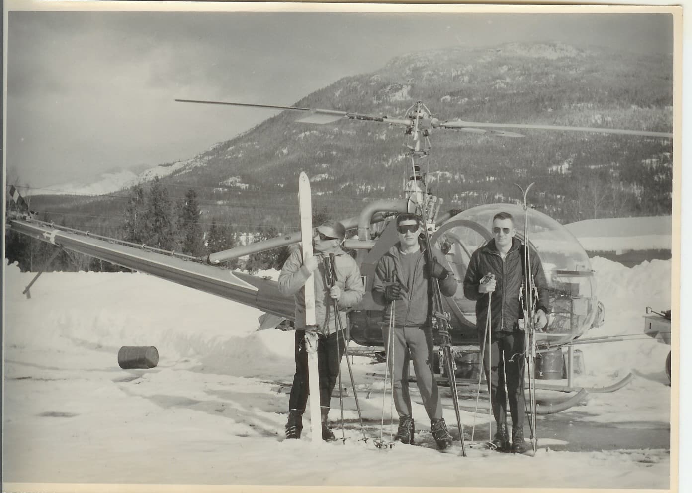 heli skiing group in front of helicopter