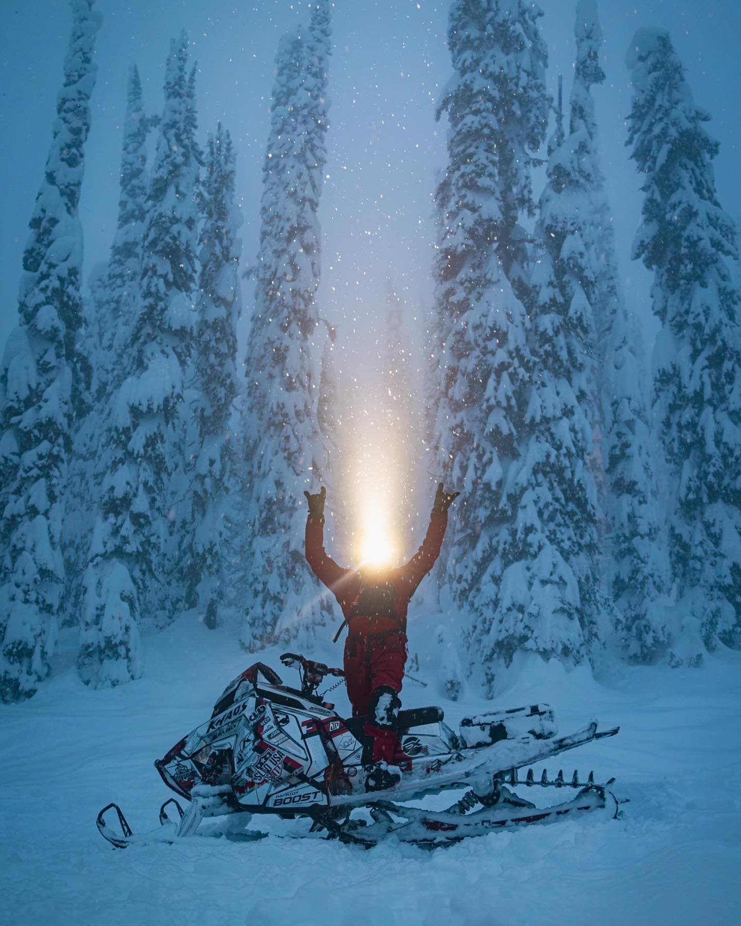 guy standing next to sled at dusk