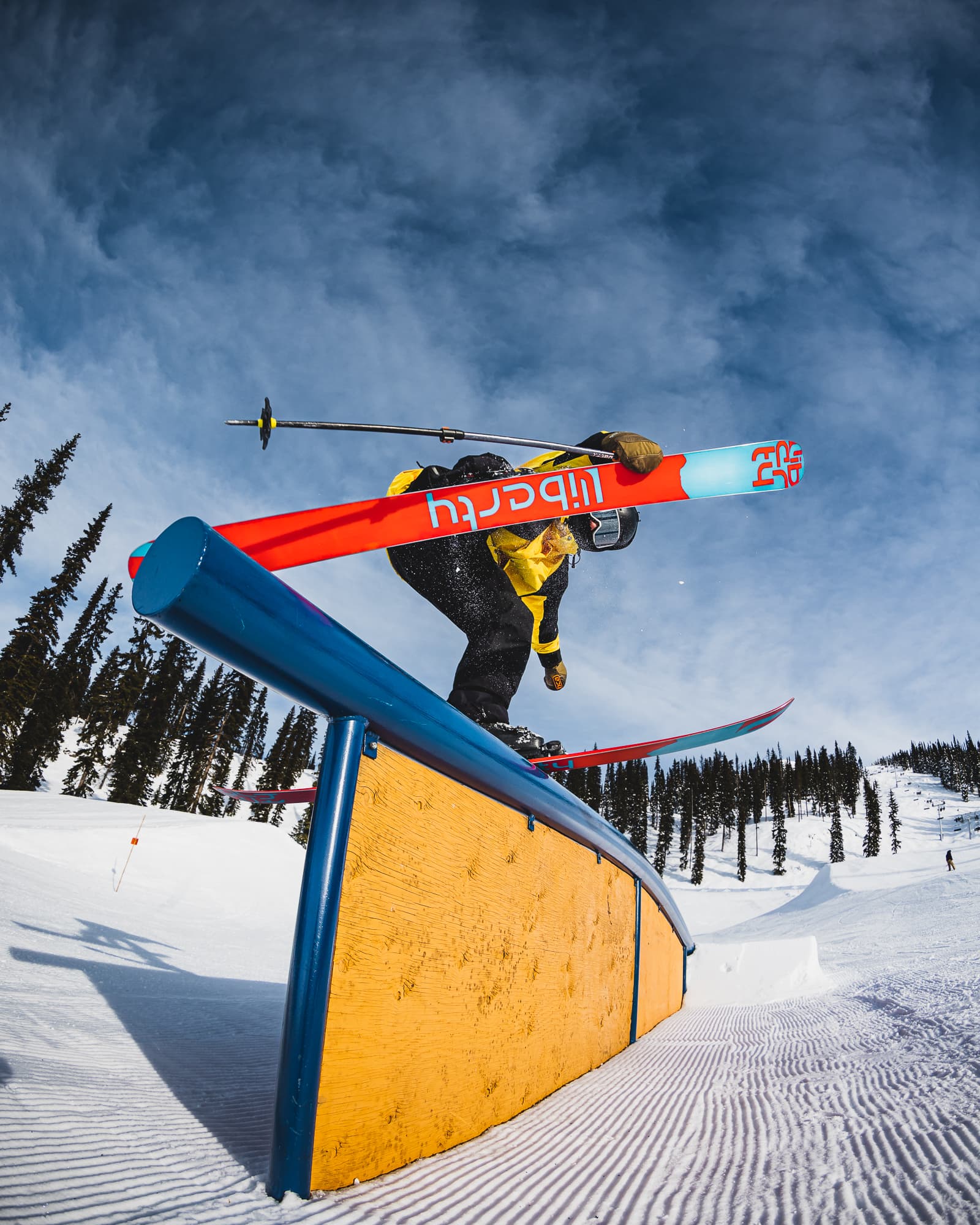 skier on ramp in terrain park doing trick