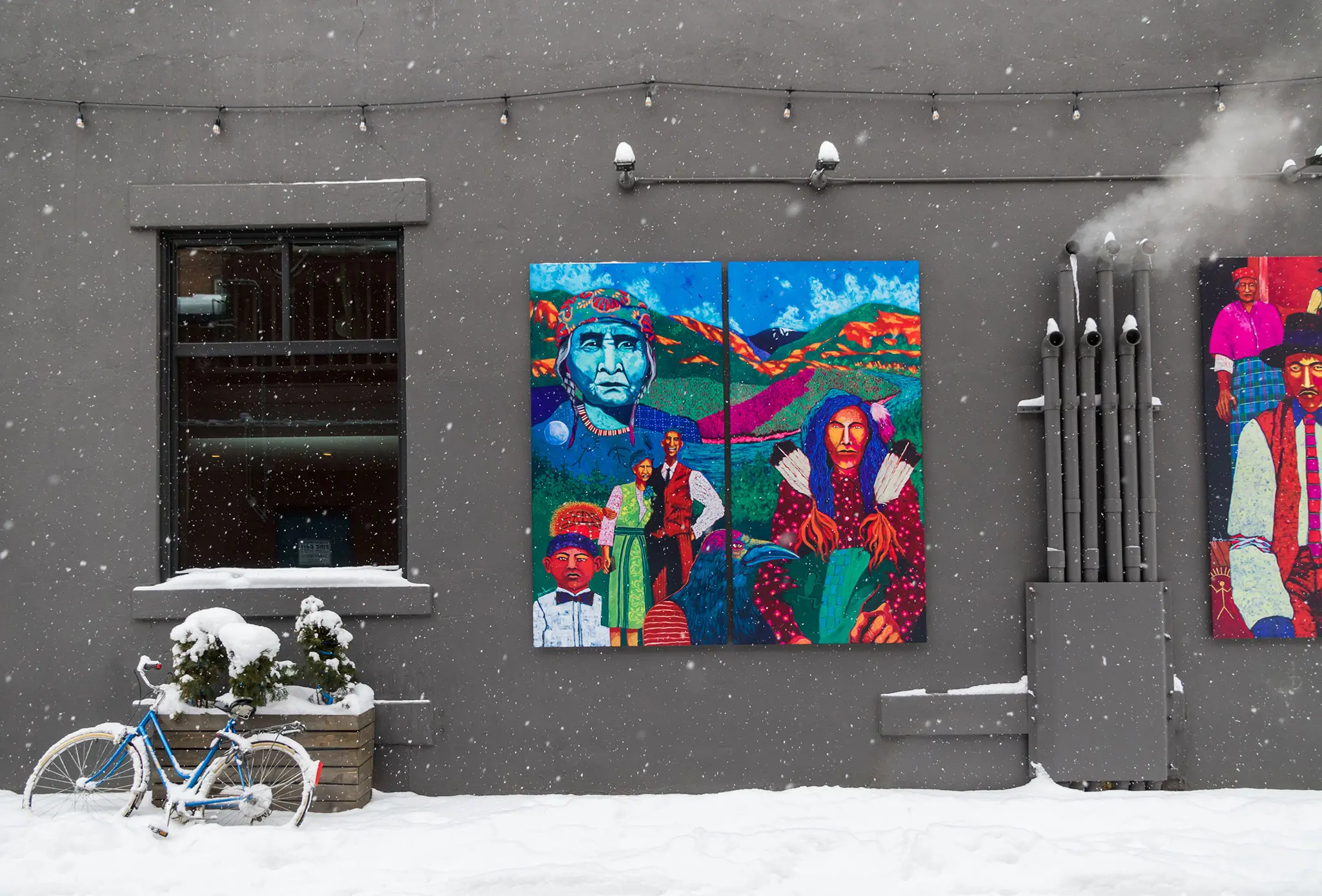 art on display in alleyway covered in snow