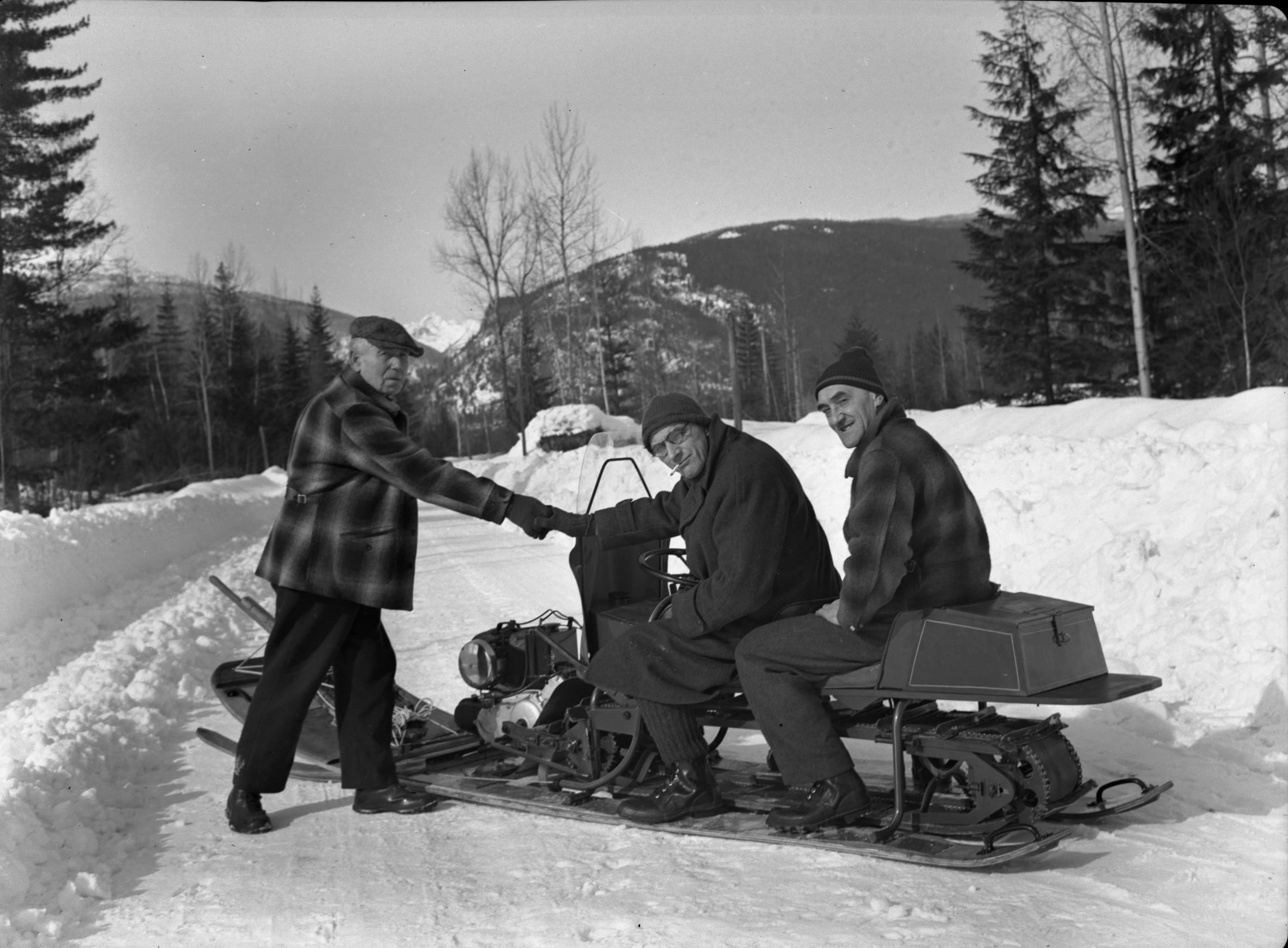 three guys with snowmobile