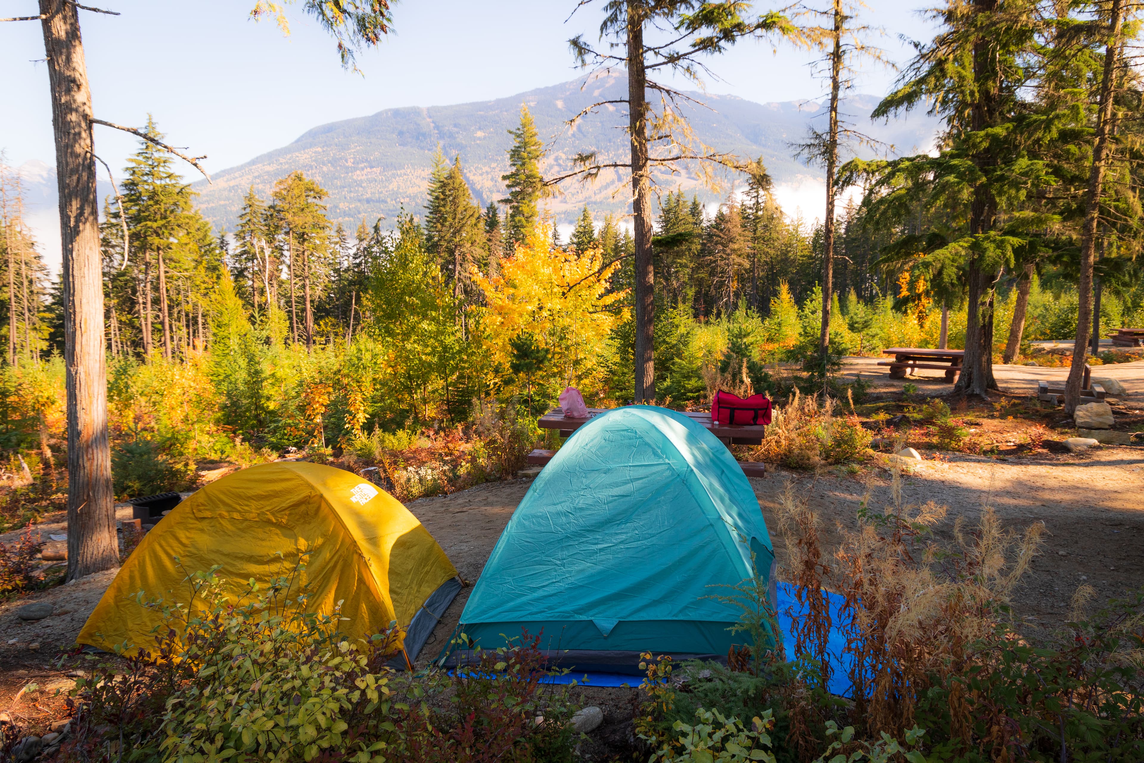 two tents set up in campsite overlooking mountains