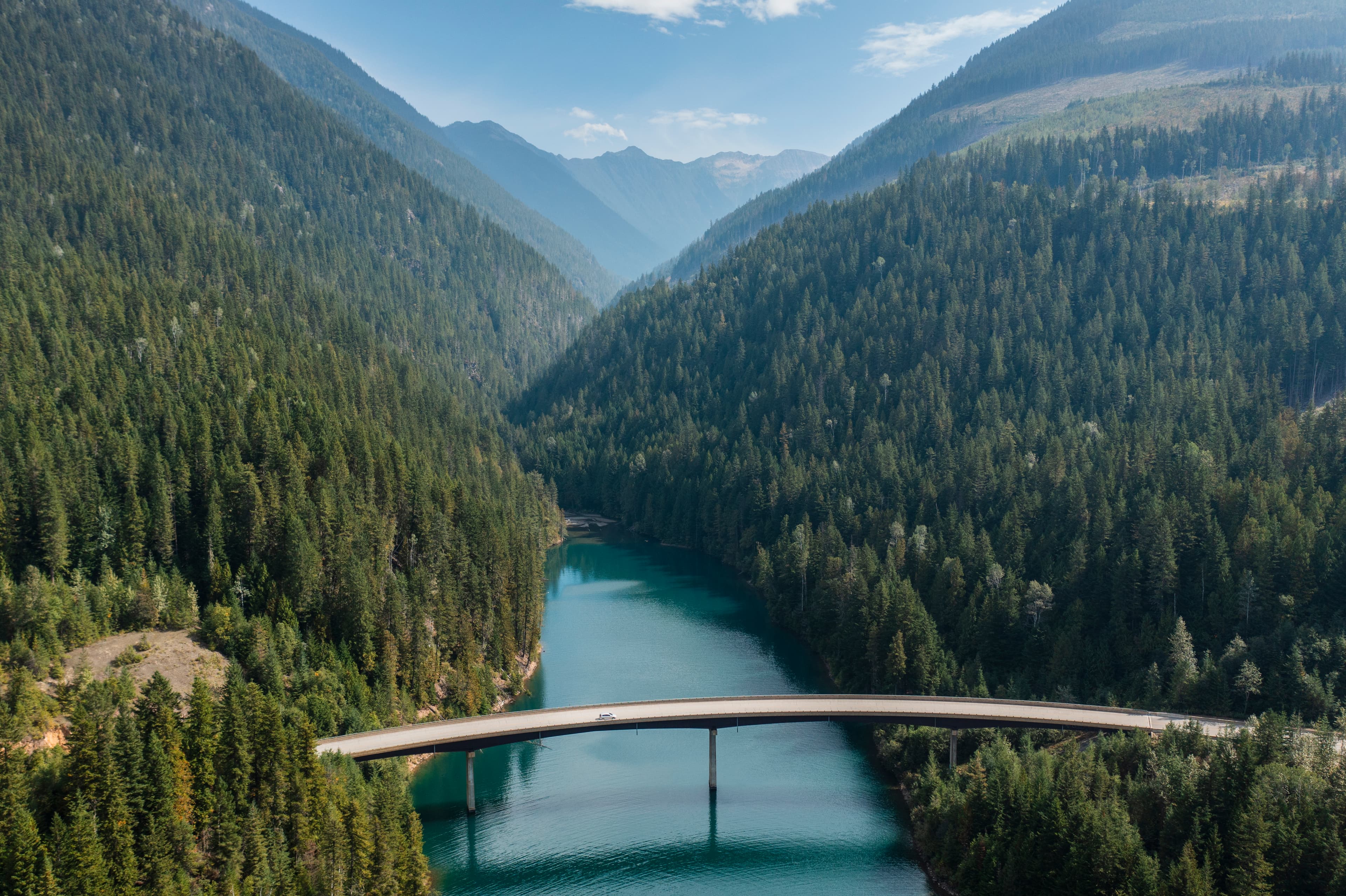 bridge crossing large body of water in mountain region