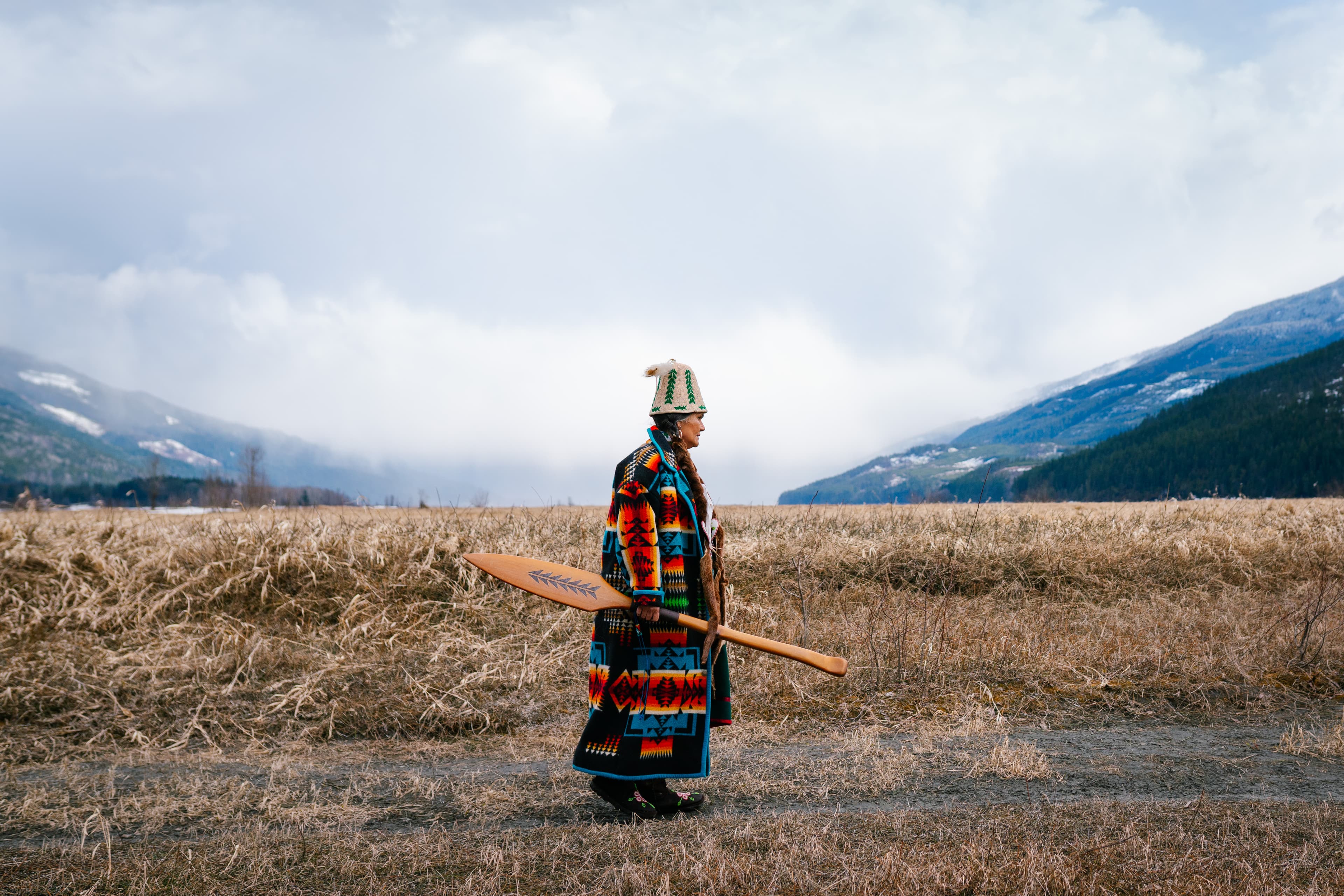 indigenous woman walking on river bed