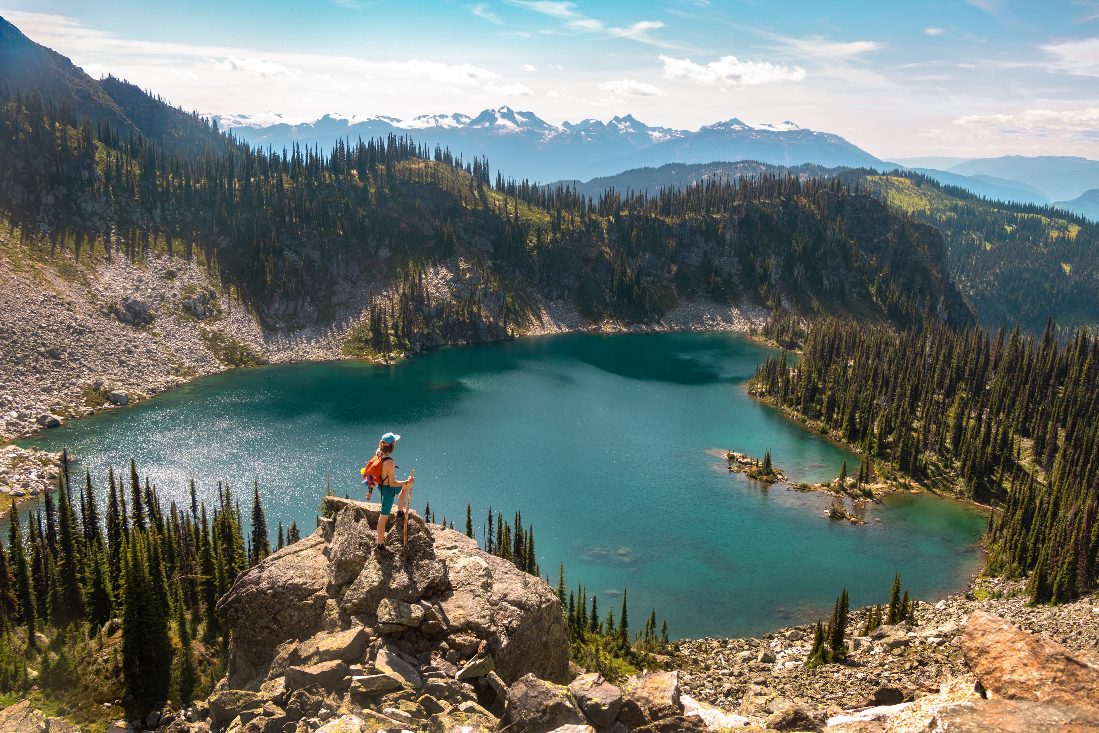 hiking woman looking out at alpine lake
