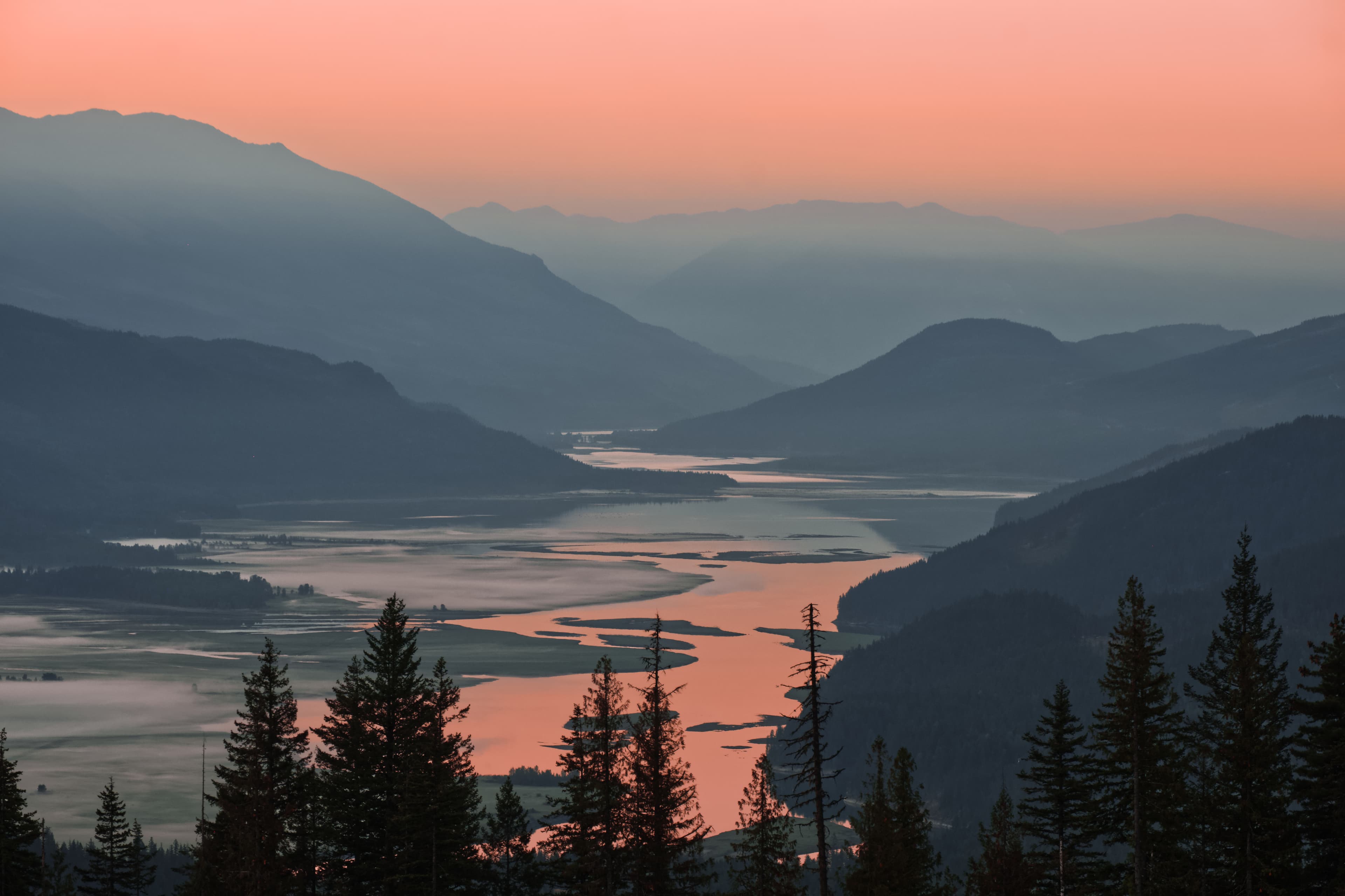 hazy sunset over the columbia river valley mountains