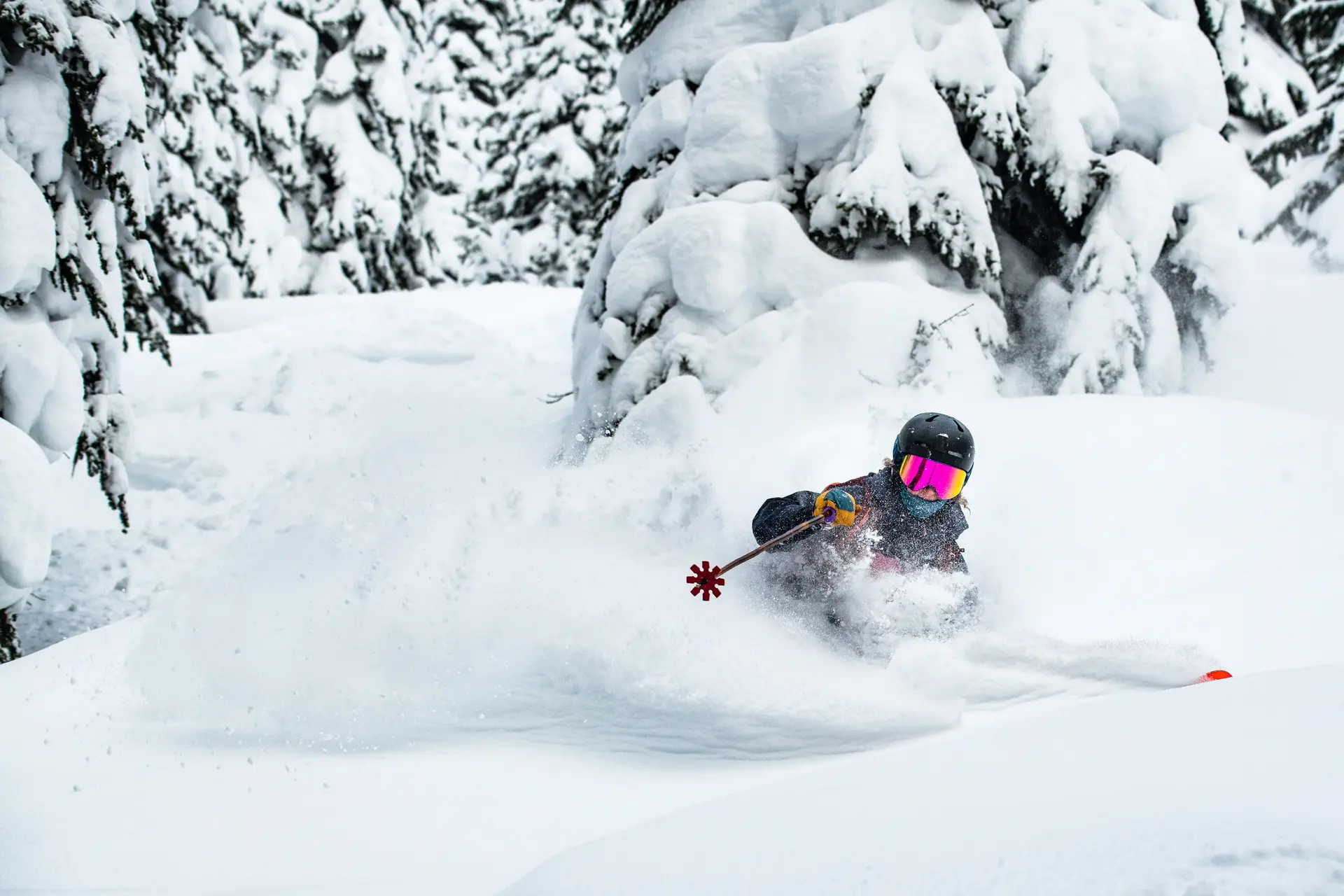 girl making ski turn in powder