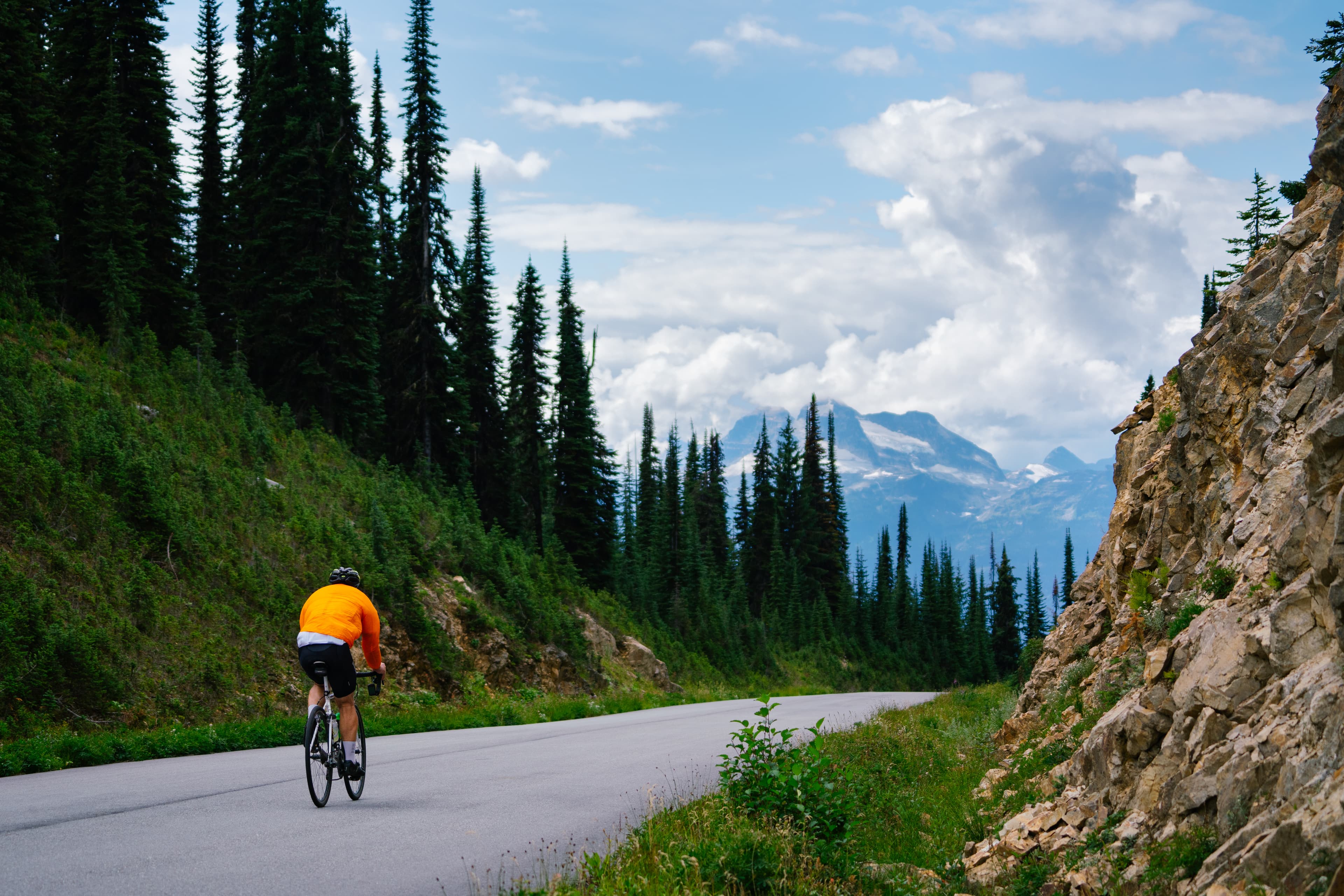 road biking along quiet paved road high above valley bottom