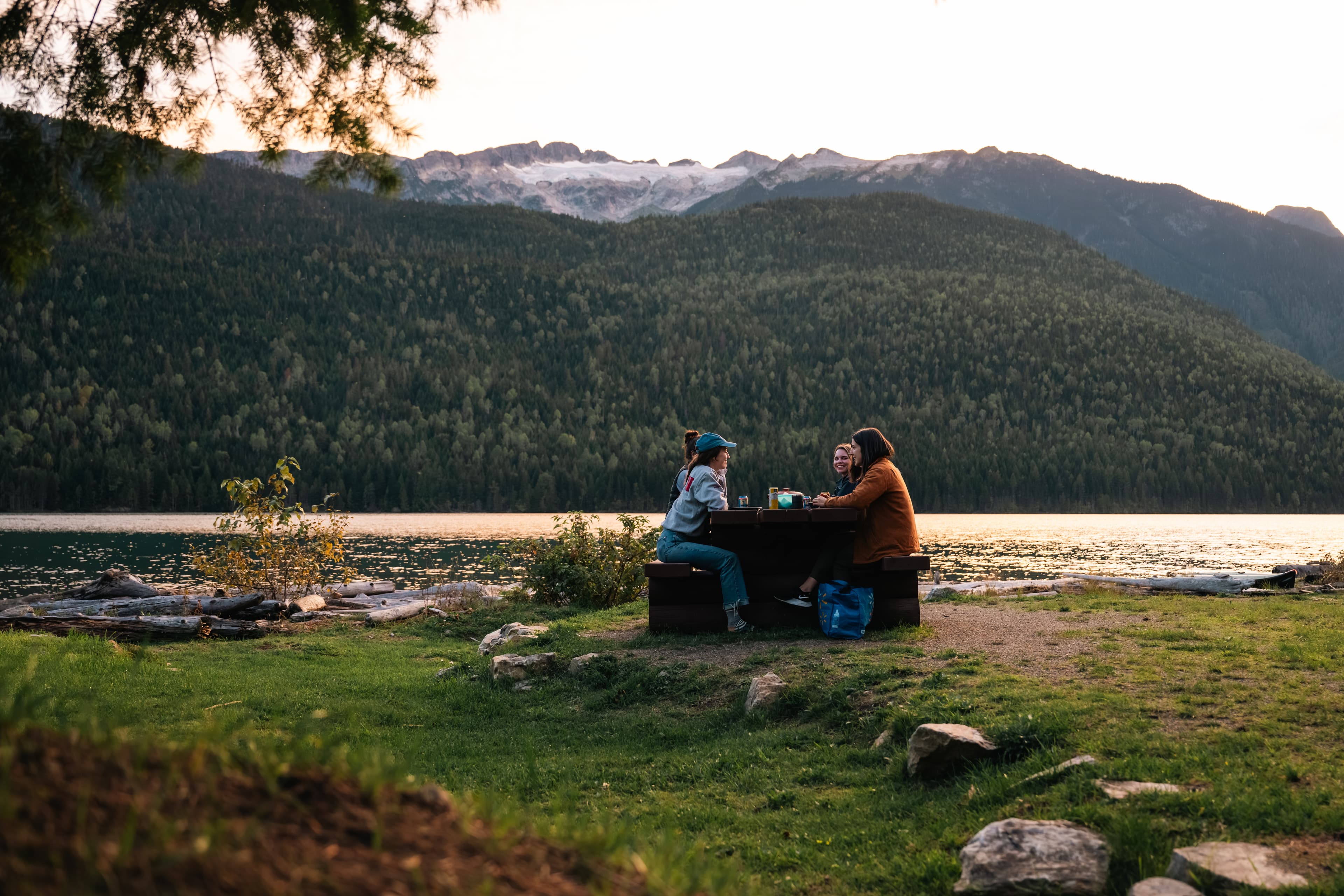 sitting at picnic table along lake