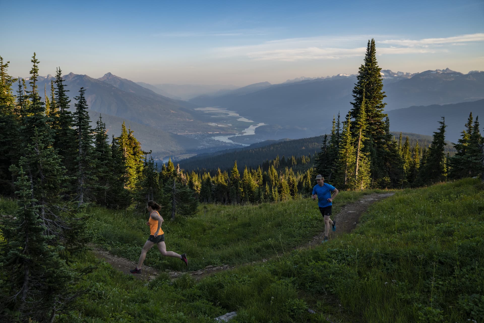 two people running with valley views