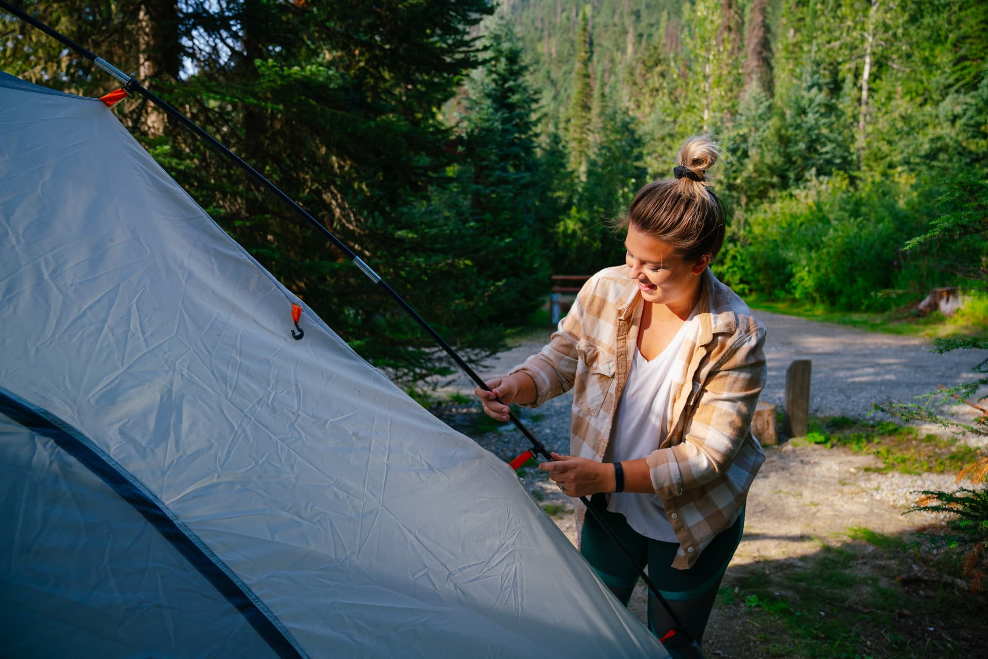 woman pitching tent