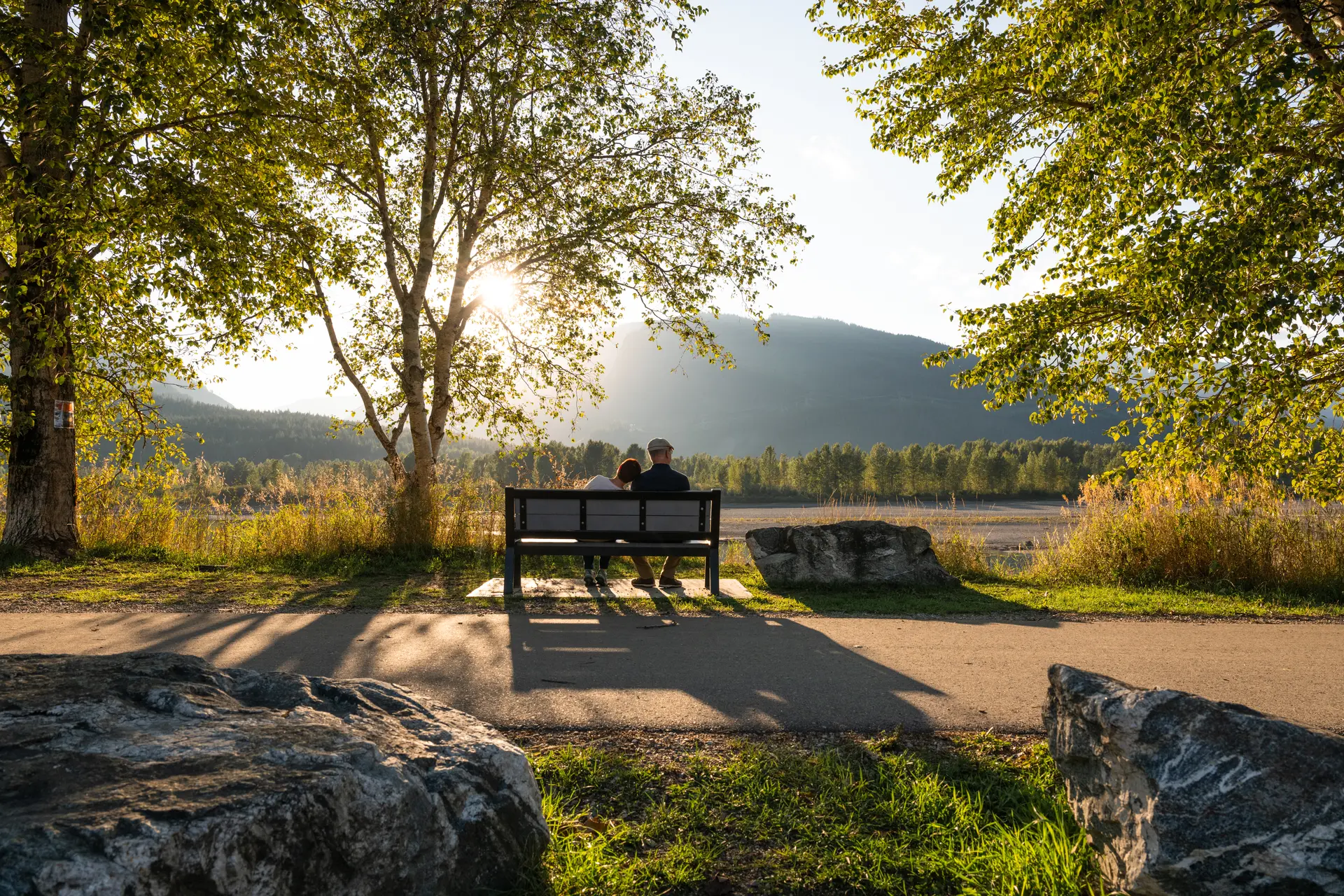 couple sitting on bench along pathway