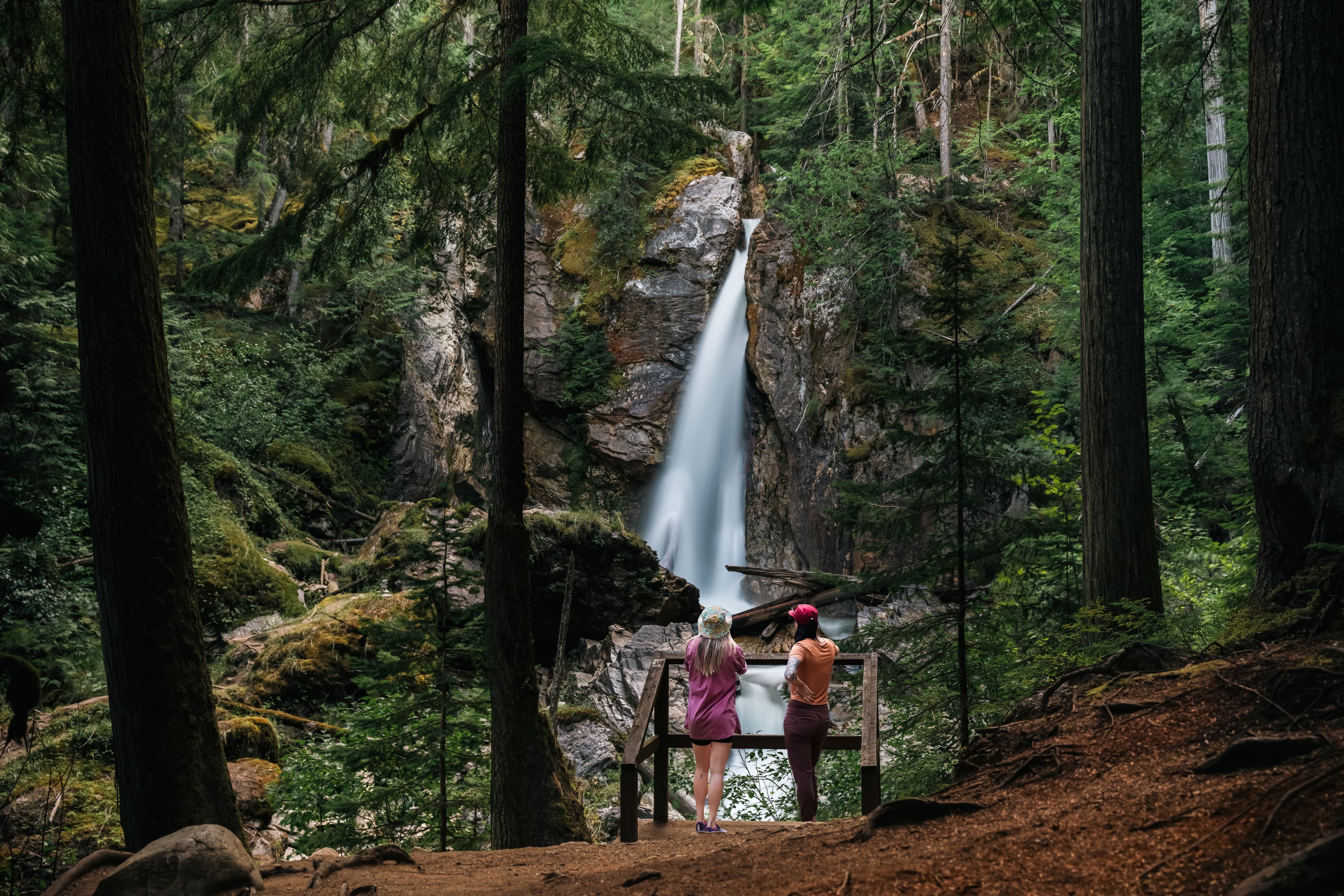 two girls on viewing platform in front of waterfalls