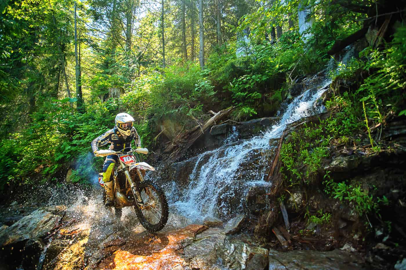 Dirt biker near waterfall Revelstoke