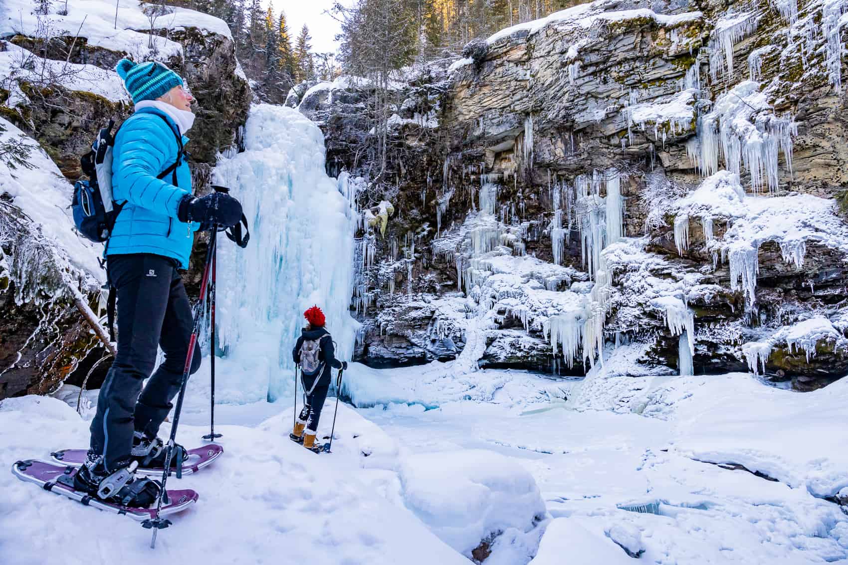 Snowshoeing near frozen waterfall Revelstoke