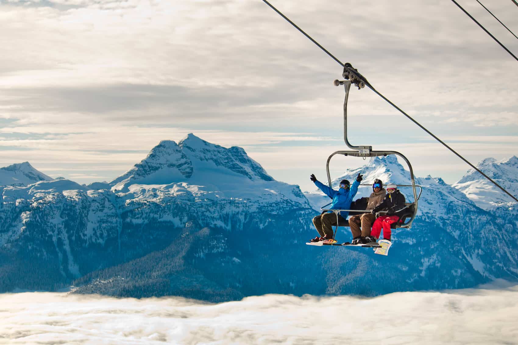 Friends on a charlift with Mount Begbie view