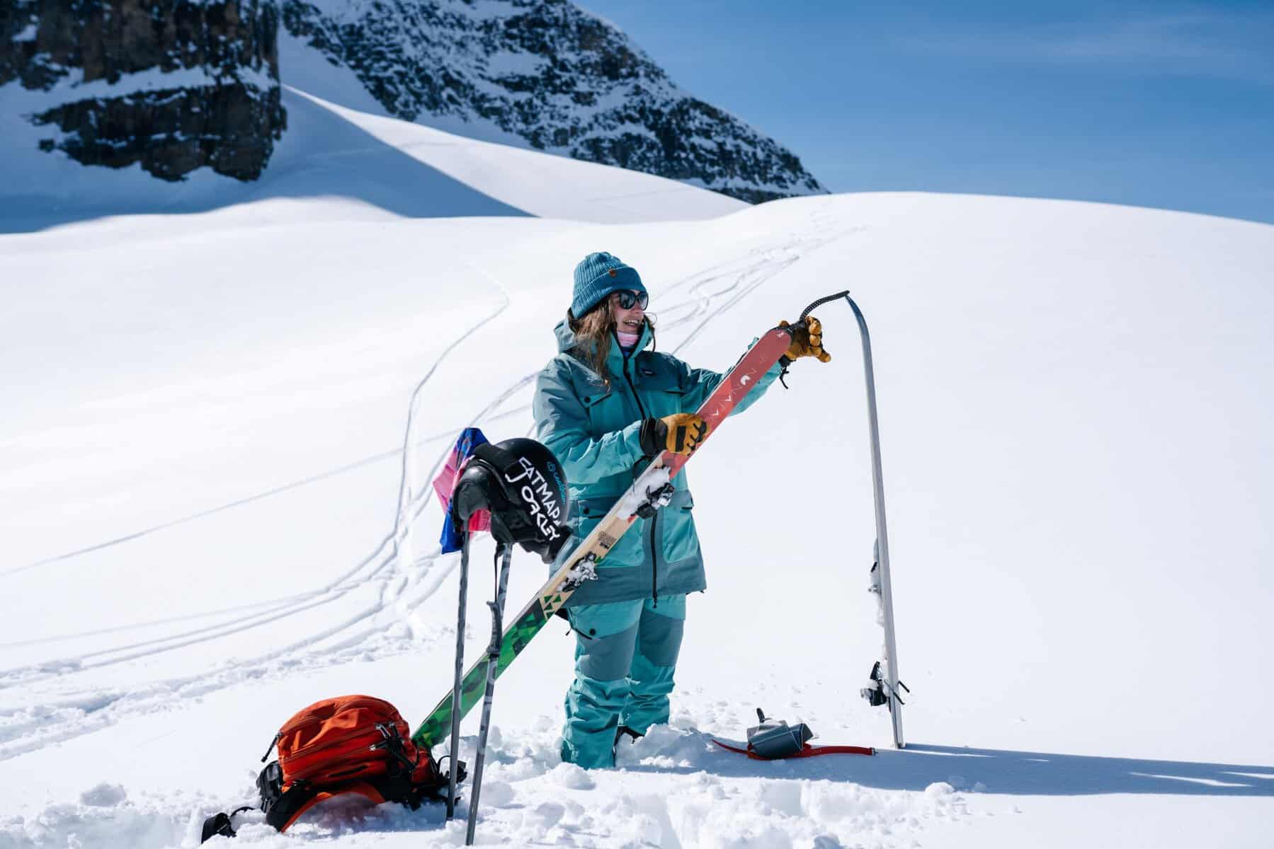 female placing on skins on touring skis