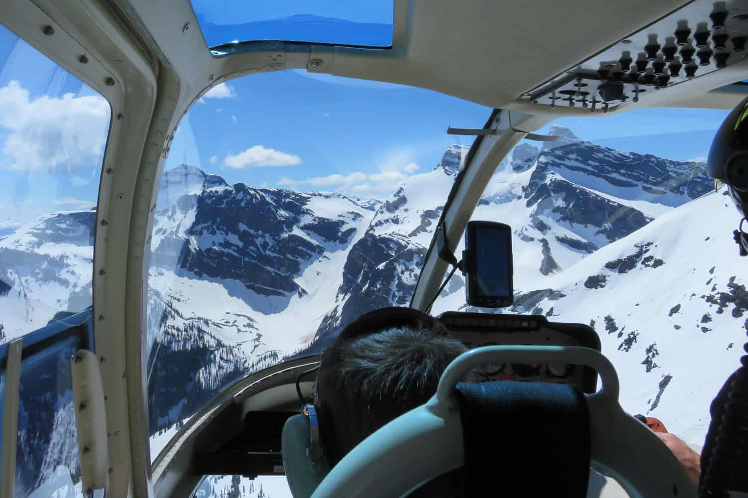 View from a helicopter over snow capped mountains