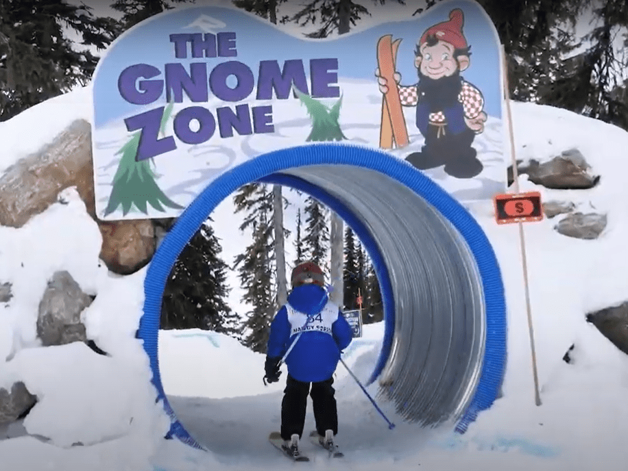 kid skiing through tunnel