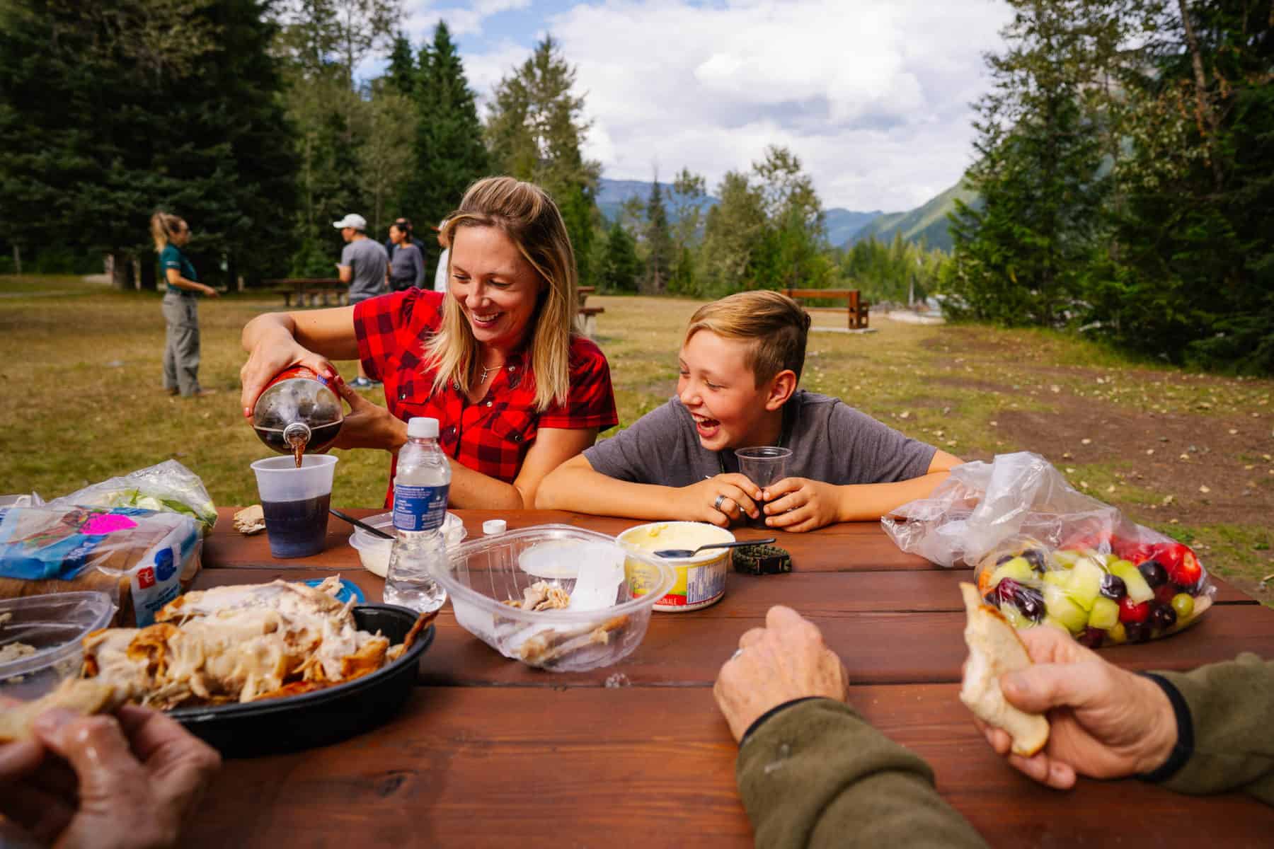 family at skunk cabbage board walk having a picnic
