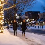 two women walking downtown revelstoke during winter evening